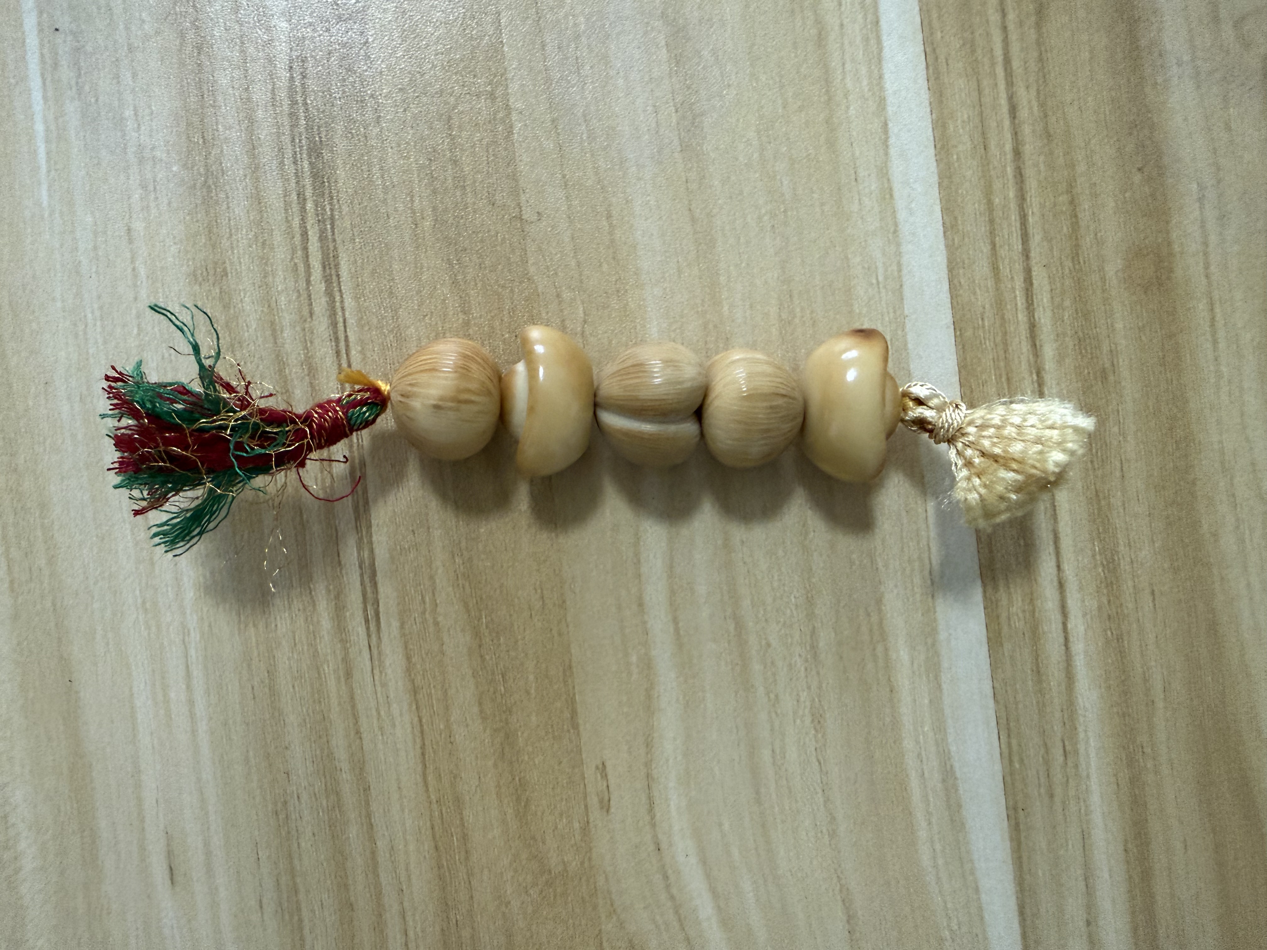Natural shell beaded bracelet strand with cream and multicolor tassels