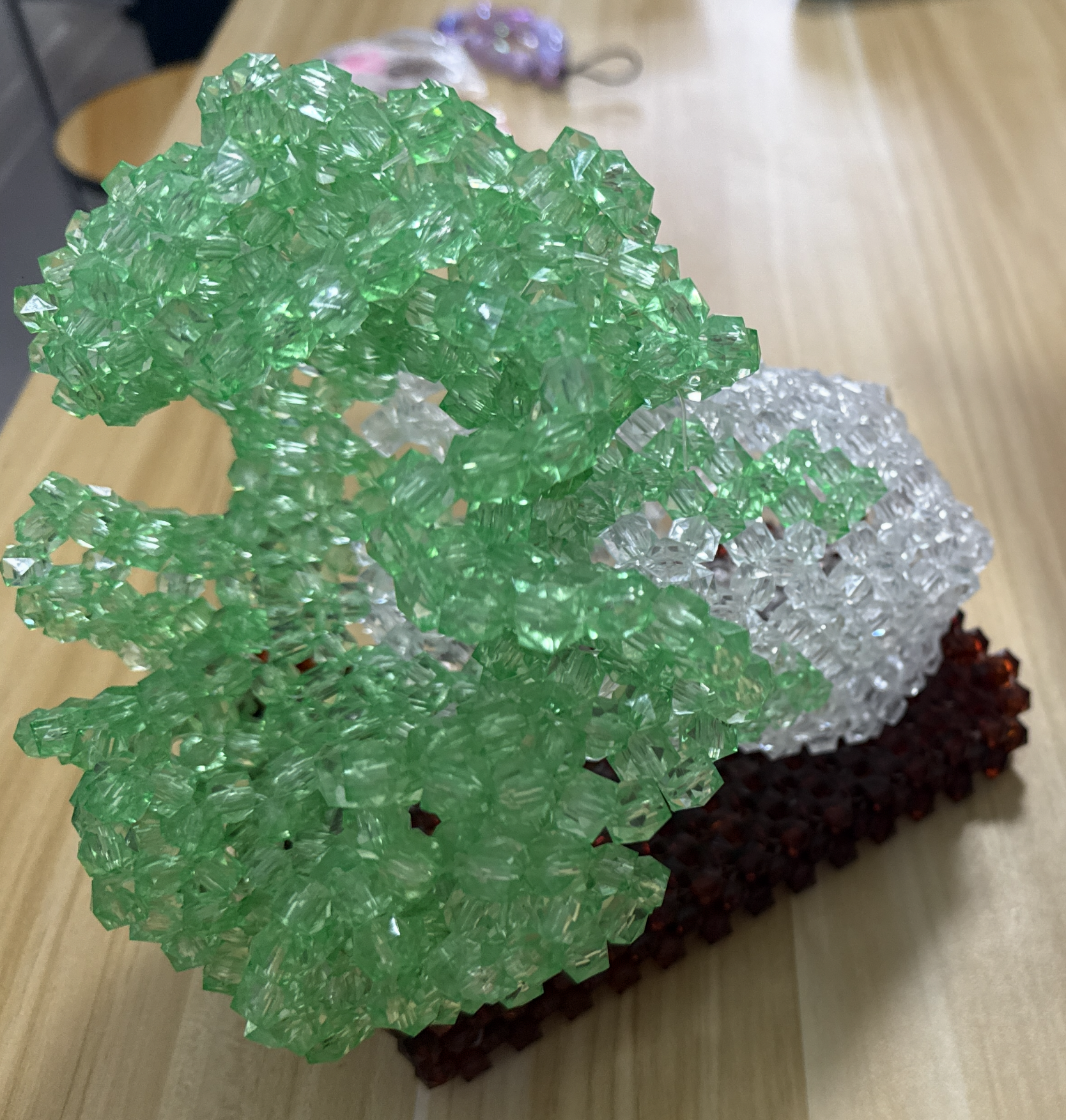 Green beaded tree sculpture on a rectangular base