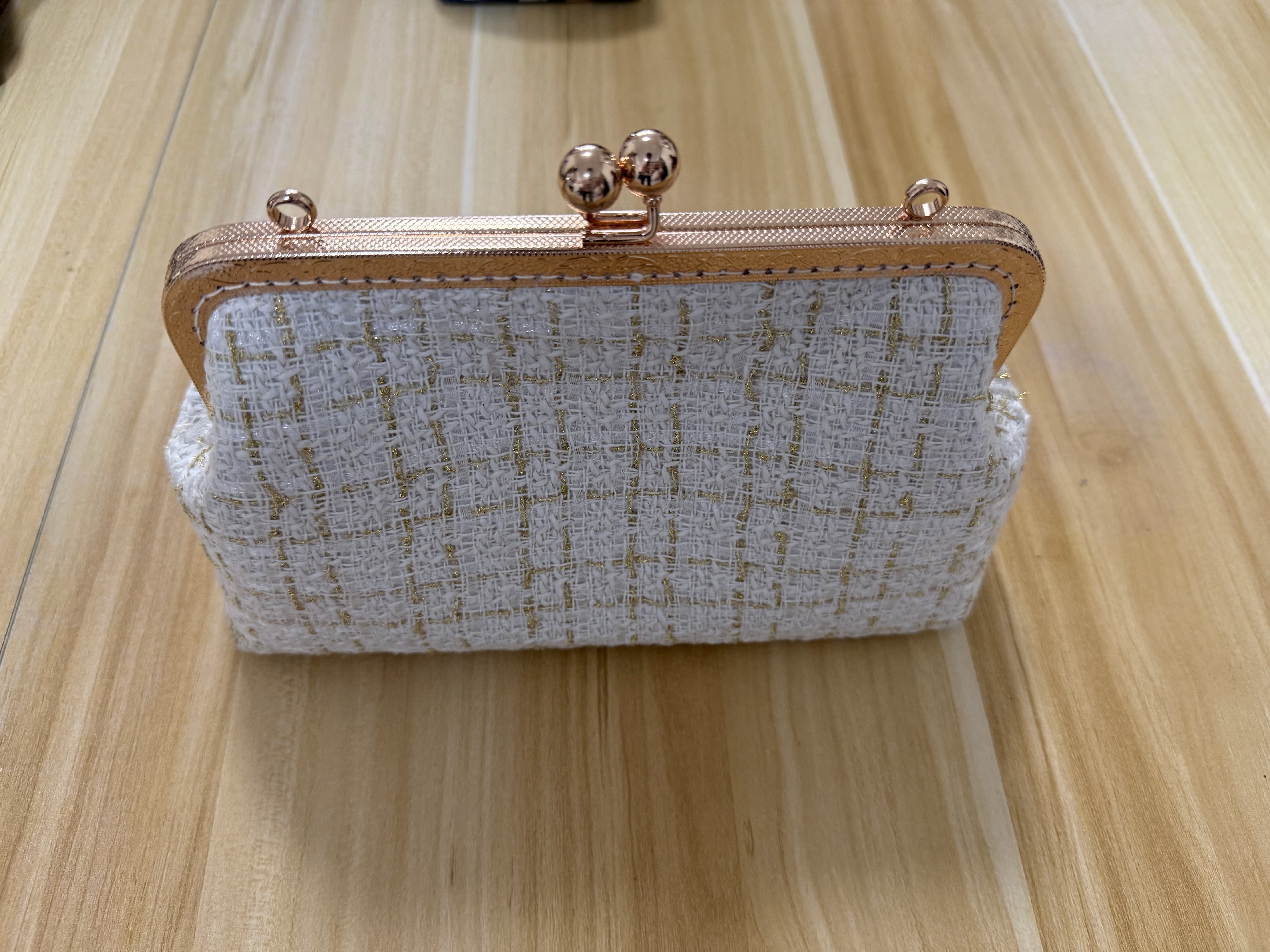 White frame clutch purse with gold woven detail